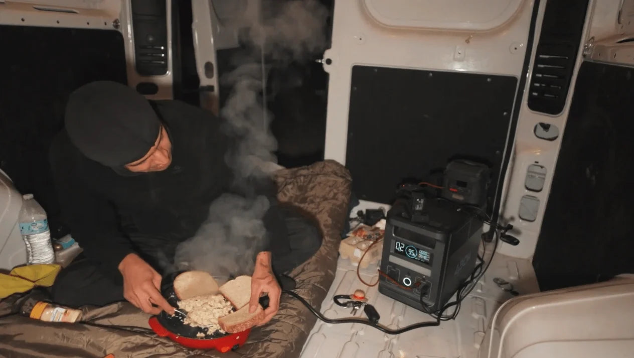 ABOK portable power station powering cooking equipment inside a vehicle.