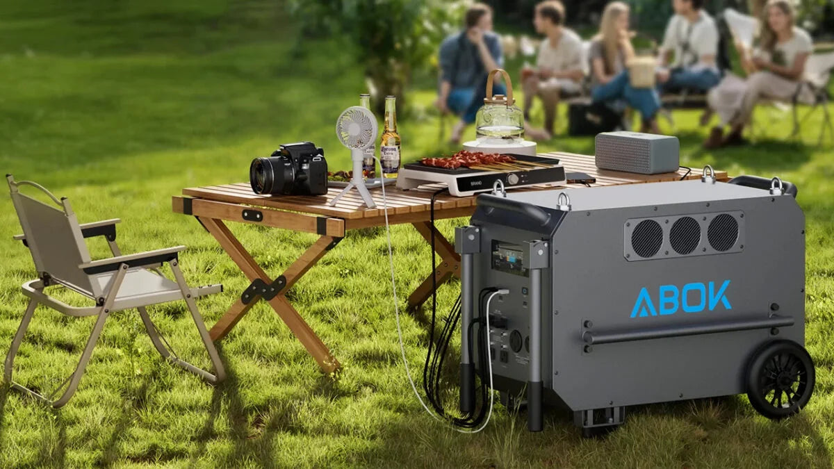 ABOK Ark Series portable power station powering appliances at an outdoor picnic.