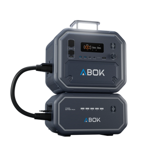 ABOK Ark2500 portable power station with its LED light raised and connected to a matching 2160Wh extra battery