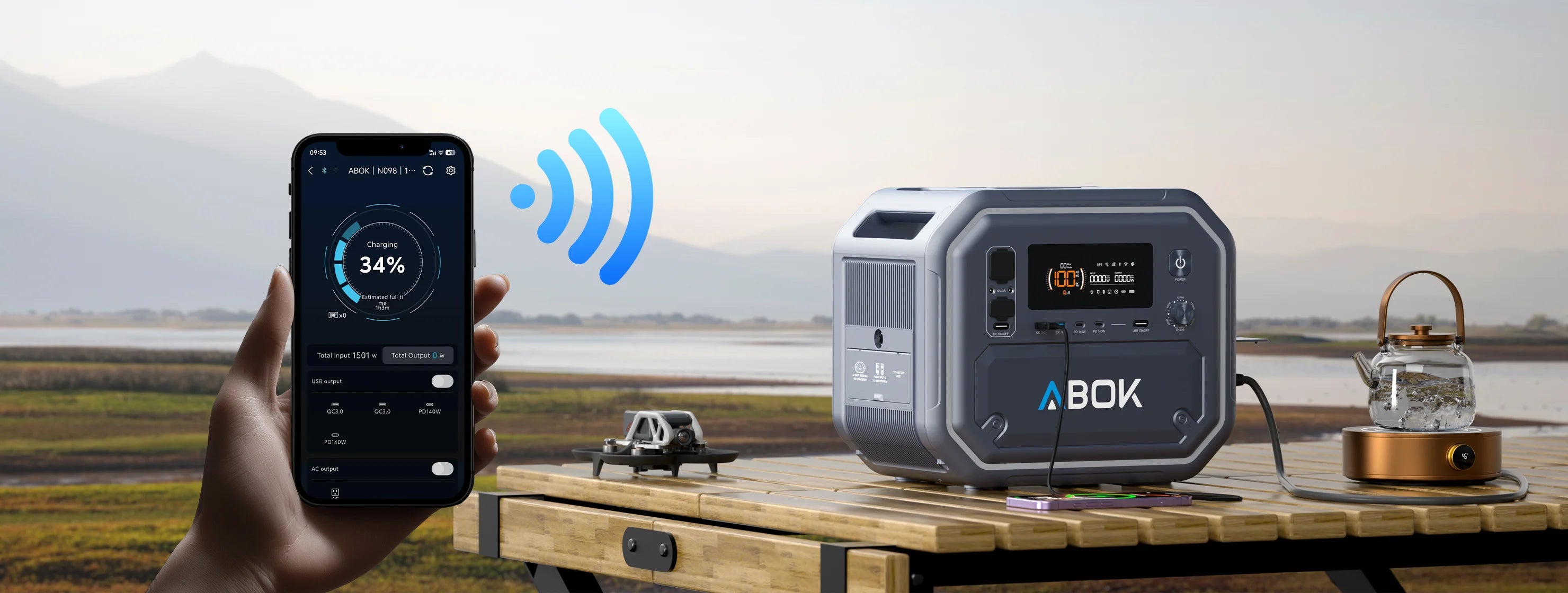 ABOK Ark2500 wide outdoor scene showing smartphone app monitoring while the portable power station powers campsite devices