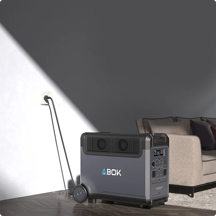 ABOK Ark3600 portable power station in a modern living room beside a sofa and wall outlet